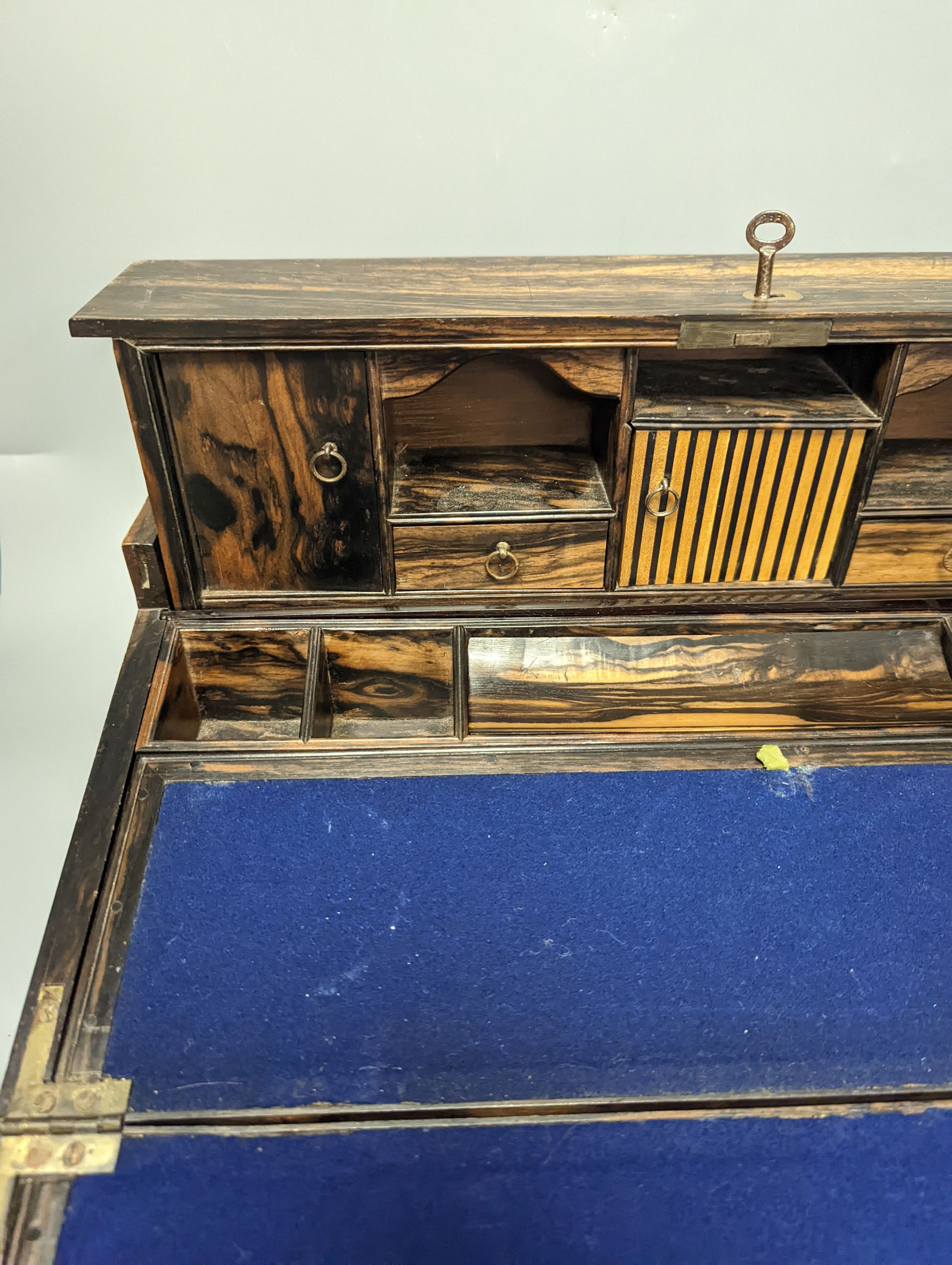A 19th Anglo-Indian coromandel writing slope, with harlequin action compartmentalised superstructure, 45cm wide